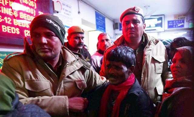 Policemen comfort the relative of a man who died in the factory fire in Bawana. (PTI) Policemen comfort the relative of a man who died in the factory fire in Bawana. (PTI)