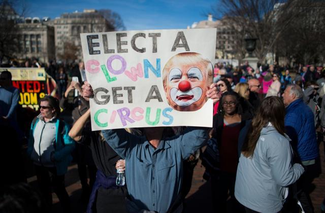 Protesters hold up signs near the White House after the Women's March on Washington. (AFP Photo) Protesters hold up signs near the White House after the Women's March on Washington. (AFP Photo)