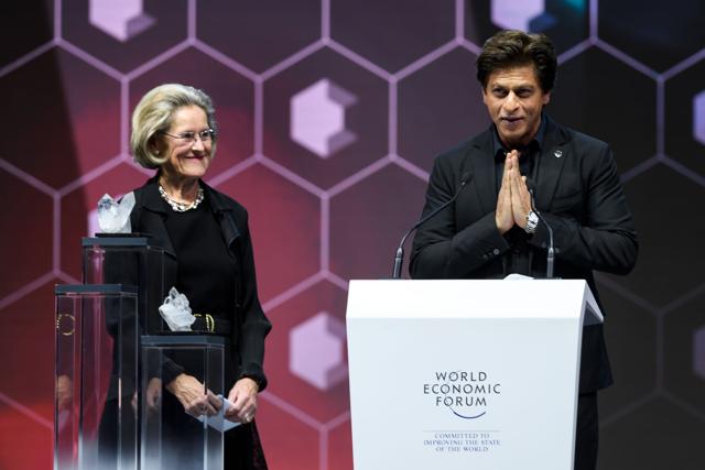 Shah Rukh Khan (R) thanks the assembly as he stands next to Schwab Foundation for Social Entrepreneurship Chairperson and Co-Founder Hilde Schwab after receiving a Crystal Award. (AFP) Shah Rukh Khan (R) thanks the assembly as he stands next to Schwab Foundation for Social Entrepreneurship Chairperson and Co-Founder Hilde Schwab after receiving a Crystal Award. (AFP)