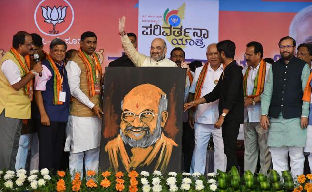 BJP chief Amit Shah being presented his portrait at a party rally in Mysuru on Thursday. (PTI) BJP chief Amit Shah being presented his portrait at a party rally in Mysuru on Thursday. (PTI)