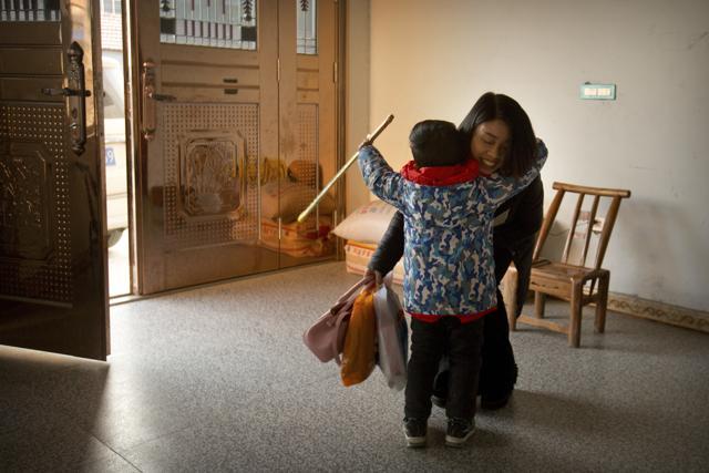 In this December 17, 2017 photo, Deng Guilian (right), the wife of Chinese labour activist Hua Haifeng, hugs their son Bo Bo, 4, as she gets ready to go to work at their home on the outskirts of Xiangyang in central China's Hubei Province. (AP) In this December 17, 2017 photo, Deng Guilian (right), the wife of Chinese labour activist Hua Haifeng, hugs their son Bo Bo, 4, as she gets ready to go to work at their home on the outskirts of Xiangyang in central China's Hubei Province. (AP)