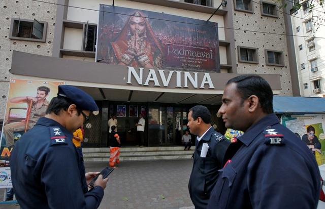Police officers stand outside a theatre after the release of Bollywood movie Padmaavat in Kolkata, January 25, 2018. (REUTERS) Police officers stand outside a theatre after the release of Bollywood movie Padmaavat in Kolkata, January 25, 2018. (REUTERS)