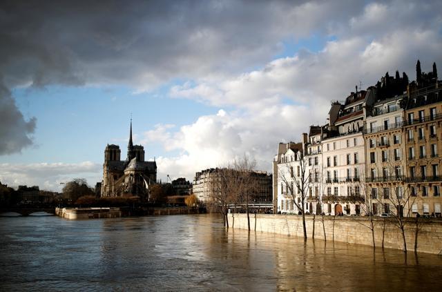 The rear of the Notre Dame Cathedral in Paris is seen as the muddy Seine River covers its banks after days of almost non-stop rain causes flooding in France, January 26, 2018. (REUTERS)