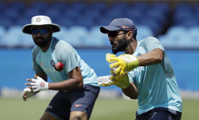 Dinesh Karthik, right, catches the ball as teammate Rohit Sharma looks on during the team practice at the Wanderers Stadium in Johannesburg, South Africa, Tuesday, Jan. 23, 2018, ahead of their 3rd and final cricket test match against South Africa. (AP) Dinesh Karthik, right, catches the ball as teammate Rohit Sharma looks on during the team practice at the Wanderers Stadium in Johannesburg, South Africa, Tuesday, Jan. 23, 2018, ahead of their 3rd and final cricket test match against South Africa. (AP)