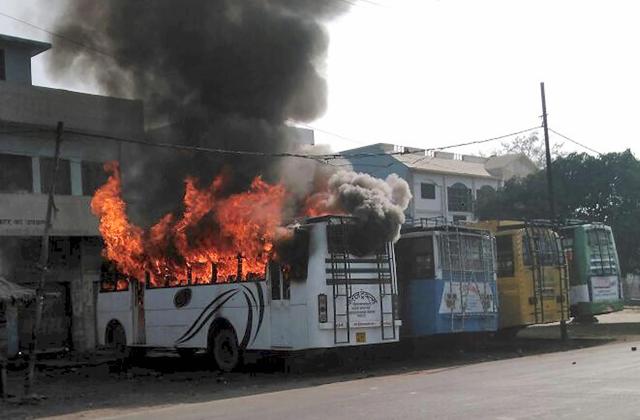 A bus set on fire on Saturday by a group of people who went on a rampage after the cremation of a young man killed during a bike rally in Kasganj. (PTI) A bus set on fire on Saturday by a group of people who went on a rampage after the cremation of a young man killed during a bike rally in Kasganj. (PTI)