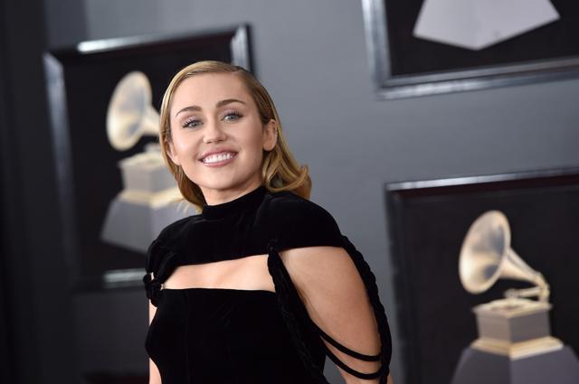 Miley Cyrus opted for the long-stem rose option to go with her black, skinny-legged trouser look. (AFP) Miley Cyrus opted for the long-stem rose option to go with her black, skinny-legged trouser look. (AFP)