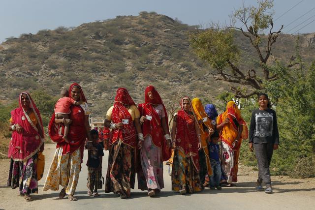 Women in Ajmer walk towards the polling booth on Monday. (HT Photo)