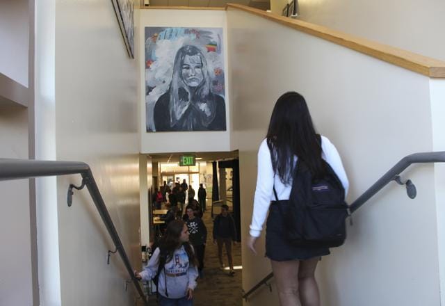 Students pass under one of James Franco's paintings displayed above a stairwell in the Media Arts Center at Palo Alto High School in Palo Alto, Calif. (AP)