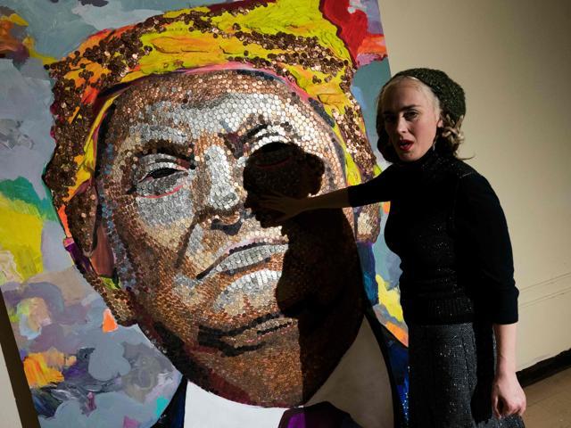 Ukranian artist Daria Marchenko is seen with her portrait of US President Donald Trump, made of US pennies, nickels and dimes. (AFP) Ukranian artist Daria Marchenko is seen with her portrait of US President Donald Trump, made of US pennies, nickels and dimes. (AFP)