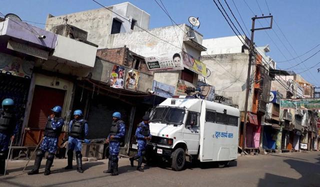 Rapid Action Force (RAF) and Provincial Armed Constabulary (PAC) personnel stand guard in Kasganj. (PTI File Photo) Rapid Action Force (RAF) and Provincial Armed Constabulary (PAC) personnel stand guard in Kasganj. (PTI File Photo)