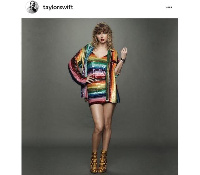 Taylor wore a rainbow-striped mini dress with her matching button-down shirt. (Instagram/ Taylor Swift) Taylor wore a rainbow-striped mini dress with her matching button-down shirt. (Instagram/ Taylor Swift)