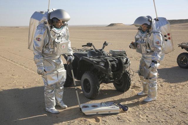 Two scientists test space suits and a geo-radar for use in a future Mars mission in the Dhofar desert of southern Oman. (AP Photo)