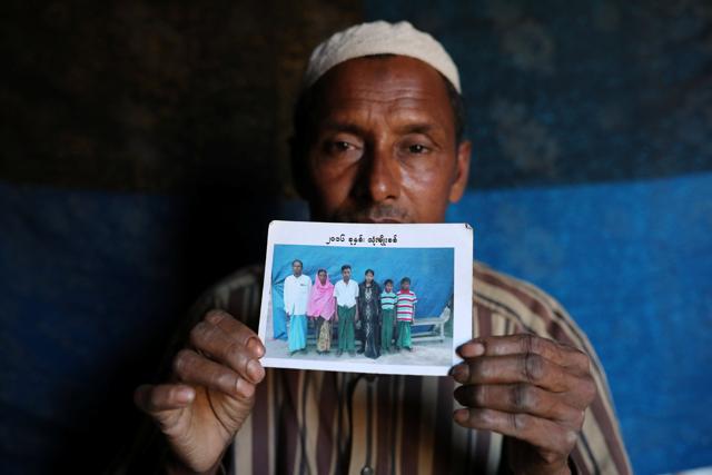 Abdu Shakur, whose son Rashid Ahmed was among 10 Rohingya men killed by Myanmar security forces and Buddhist villagers on September 2, 2017, holds a family picture at Kutupalong camp in Cox's Bazar, Bangladesh, January 19, 2018. (Reuters Photo) Abdu Shakur, whose son Rashid Ahmed was among 10 Rohingya men killed by Myanmar security forces and Buddhist villagers on September 2, 2017, holds a family picture at Kutupalong camp in Cox's Bazar, Bangladesh, January 19, 2018. (Reuters Photo)