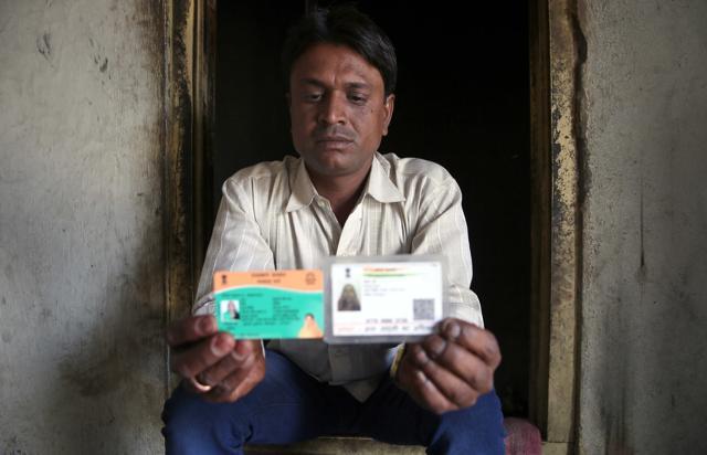Narayan Balai shows Aadhaar and Bhamashah Yojana cards of late Sohani Devi, at his residence at Balai settlement, in Suvana village, Bhilwara, Rajasthan , on February 8, 2018. (Himanshu Vyas / Hindustan Times)