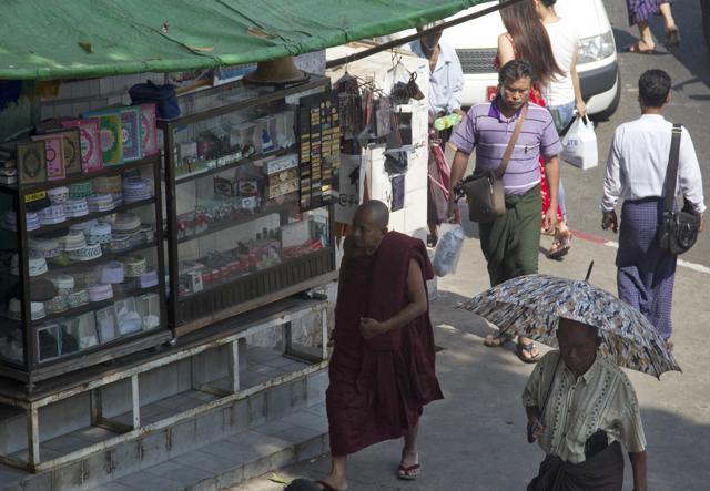 A Buddhist monk walks past a shop selling Islamic religious items in downtown Yangon, Myanmar. (AP) A Buddhist monk walks past a shop selling Islamic religious items in downtown Yangon, Myanmar. (AP)