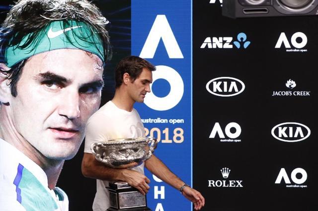 Roger Federer arrives for a press conference with the trophy after winning the Australian Open men's singles final against Croatia's Marin Cilic. (REUTERS) Roger Federer arrives for a press conference with the trophy after winning the Australian Open men's singles final against Croatia's Marin Cilic. (REUTERS)