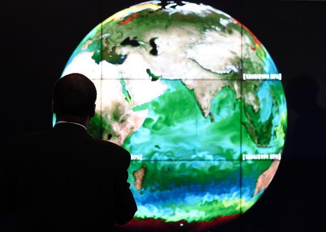 A delegate looking at a projection of the Earth on the opening day of the COP 21 United Nations conference on climate change, on November 30, 2015 in Le Bourget, France. (AFP File Photo) A delegate looking at a projection of the Earth on the opening day of the COP 21 United Nations conference on climate change, on November 30, 2015 in Le Bourget, France. (AFP File Photo)