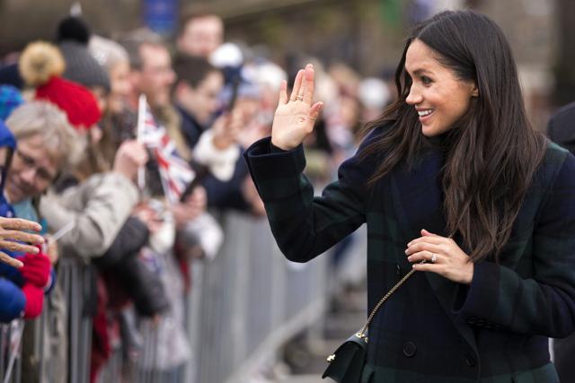 Meghan Markle waves as she meets members of the public. (AFP) Meghan Markle waves as she meets members of the public. (AFP)