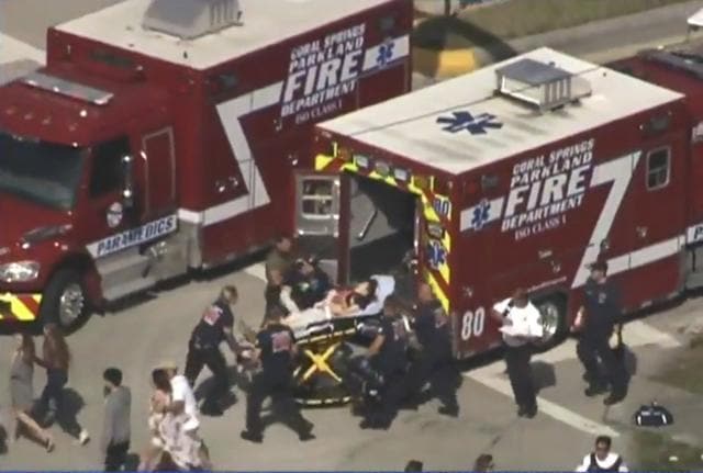 Rescue workers prepare to transport a victim on a stretcher near Marjory Stoneman Douglas High School following a shooting incident in Parkland, Florida, US. (Reuters) Rescue workers prepare to transport a victim on a stretcher near Marjory Stoneman Douglas High School following a shooting incident in Parkland, Florida, US. (Reuters)