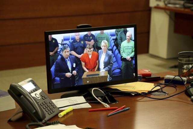 A video monitor shows school shooting suspect Nikolas Cruz, making an appearance before Judge Kim Theresa Mollica in Broward County Court. (AP Photo) A video monitor shows school shooting suspect Nikolas Cruz, making an appearance before Judge Kim Theresa Mollica in Broward County Court. (AP Photo)