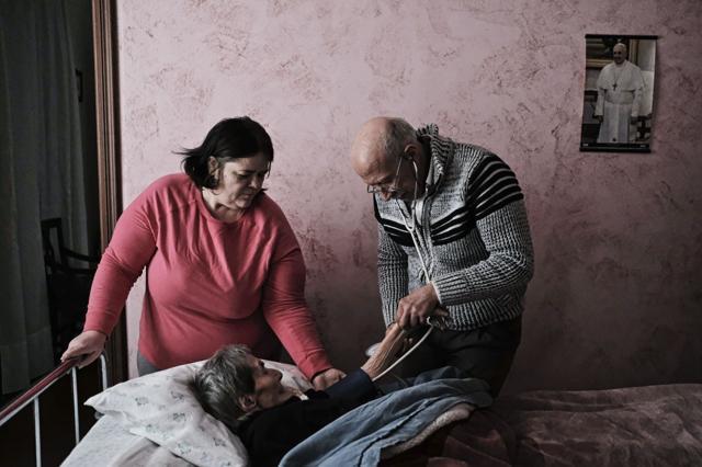 Anfosso (R) checks the blood pressure of his 98-year-old patient Luigina Sobrero (C). (AFP) Anfosso (R) checks the blood pressure of his 98-year-old patient Luigina Sobrero (C). (AFP)