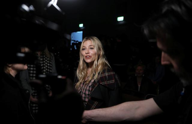 Actor Sienna Miller is interviewed at the Burberry show. (REUTERS)