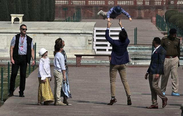 Canadian Prime Minister Justin Trudeau, plays with Hadrien as his wife, Sophie Gregoire Trudeau,fourth left, daughter, daughter Ella-Grace, second left, and son Xavier watch during their visit to the Taj Mahal. (AP) Canadian Prime Minister Justin Trudeau, plays with Hadrien as his wife, Sophie Gregoire Trudeau,fourth left, daughter, daughter Ella-Grace, second left, and son Xavier watch during their visit to the Taj Mahal. (AP)