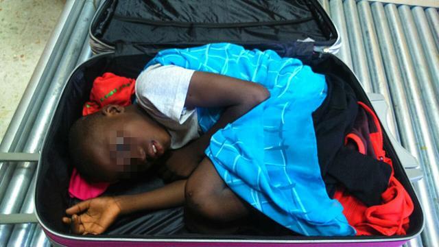 A file handout photo released on May 08, 2015 by the Spanish Guardia Civil shows 8-year-old Ivorian boy Adou Ouattara hidden in a suitcase which was controlled in Ceuta, the Spanish enclave in the north of Morocco. (AFP File Photo) A file handout photo released on May 08, 2015 by the Spanish Guardia Civil shows 8-year-old Ivorian boy Adou Ouattara hidden in a suitcase which was controlled in Ceuta, the Spanish enclave in the north of Morocco. (AFP File Photo)