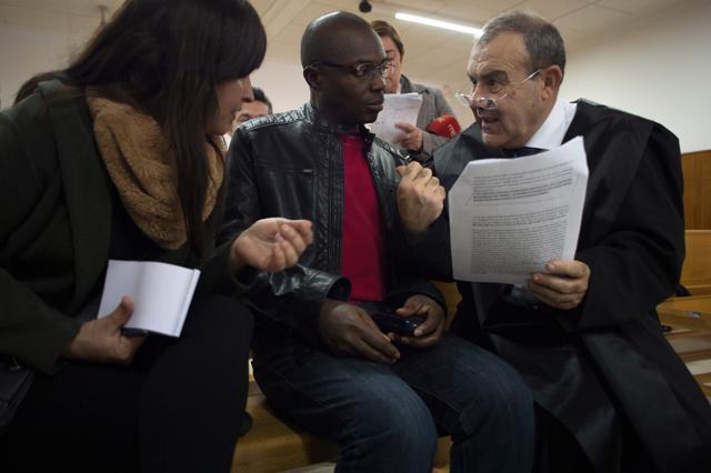 Ali Ouattara, 45 (centre) talks with his lawyer Juan Isidro Fernandez (right) in court during his trial in Ceuta. (AFP Photo) Ali Ouattara, 45 (centre) talks with his lawyer Juan Isidro Fernandez (right) in court during his trial in Ceuta. (AFP Photo)