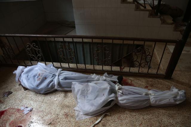 The bodies of civilians who were killed in Syrian army bombardment on the town of Hamouria in the rebel-held enclave of Eastern Ghouta. (AFP Photo) The bodies of civilians who were killed in Syrian army bombardment on the town of Hamouria in the rebel-held enclave of Eastern Ghouta. (AFP Photo)