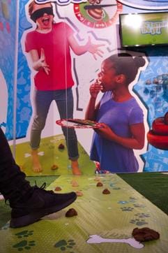 In Don't Step In It, players place mounds of brown compound on the game mat, then take turns spinning the spinner to find out how many steps to take across the mat while blindfolded. (AP)