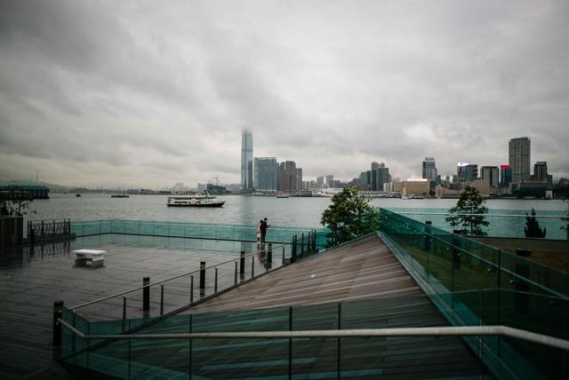 A couple stand next to US artist Jenny Holzer's Truism's, Money Creates Taste. (AFP)