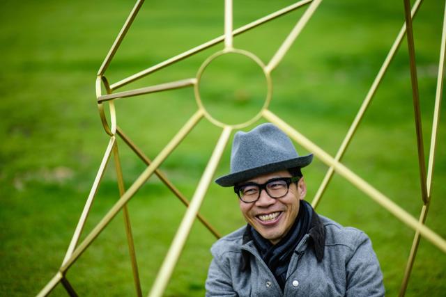 Local artist Kacey Wong sits in his sculpture Asteroids &amp; Comets. (AFP)