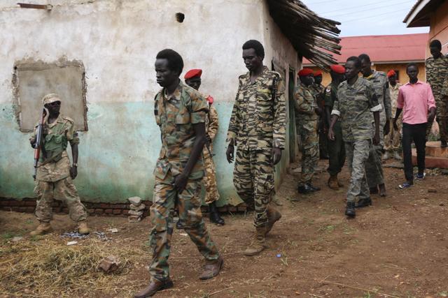 South Sudanese soldiers accused of gang-raping five foreigners, murdering a local journalist and looting a hotel, are led to their prison van after attending a hearing of their trial in the capital Juba/ (AP File Photo) South Sudanese soldiers accused of gang-raping five foreigners, murdering a local journalist and looting a hotel, are led to their prison van after attending a hearing of their trial in the capital Juba/ (AP File Photo)