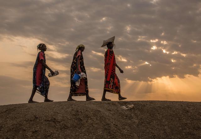 Internally displaced women walk to a food distribution in the early morning at the Protection of Civilian site (PoC) in Bentiu, South Sudan. (AFP File Photo) Internally displaced women walk to a food distribution in the early morning at the Protection of Civilian site (PoC) in Bentiu, South Sudan. (AFP File Photo)