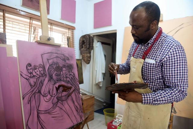 Oliver Enwonwu, president of the Society of Nigerian Artists and son of late Professor Ben Enwonwu, paints a drawing at his Omenka studio in Lagos, on February 19, 2018. (AFP/Pius Utomi Ekpei) Oliver Enwonwu, president of the Society of Nigerian Artists and son of late Professor Ben Enwonwu, paints a drawing at his Omenka studio in Lagos, on February 19, 2018. (AFP/Pius Utomi Ekpei)