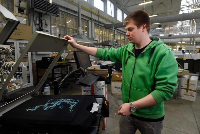 A worker of OP Tiger factory prints on a T-shirt a map designed by Matej Hosek. (AFP) A worker of OP Tiger factory prints on a T-shirt a map designed by Matej Hosek. (AFP)