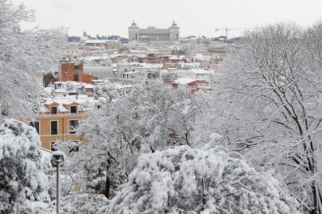 Roofs are seen covered in snow during a heavy snowfall in downtown Rome. (Reuters)