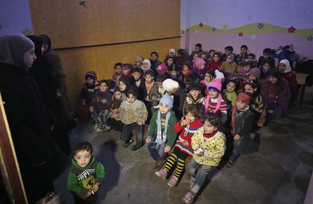 A picture dated on January 28, 2018 shows a group of Syrian children who escaped from regime bombardment sitting in a make-shift classroom in a basement that is used as a bomb shelter in Arbin, in the besieged Eastern Ghouta region. (AFP Photo) A picture dated on January 28, 2018 shows a group of Syrian children who escaped from regime bombardment sitting in a make-shift classroom in a basement that is used as a bomb shelter in Arbin, in the besieged Eastern Ghouta region. (AFP Photo)