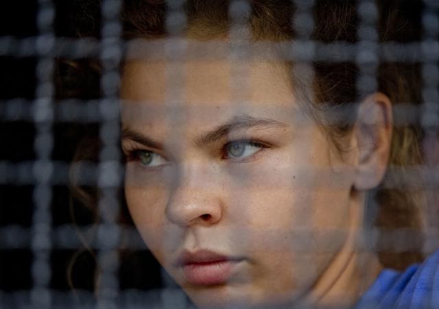 Anastasia Vashukevich sits in a police transport vehicle outside a detention center in Pattaya, south of Bangkok, Thailand. She wants to exchange information on alleged Russian ties to U.S. President Donald Trump’s campaign for her own personal safety. (AP) Anastasia Vashukevich sits in a police transport vehicle outside a detention center in Pattaya, south of Bangkok, Thailand. She wants to exchange information on alleged Russian ties to U.S. President Donald Trump’s campaign for her own personal safety. (AP)