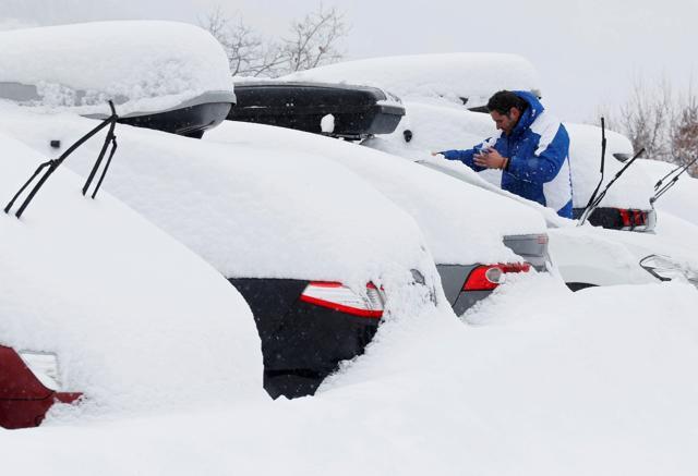 A man removes snow from the windscreen of his car as winter weather bringing snow and freezing temperatures continues, in Saint-Chaffrey, France. (Reuters) A man removes snow from the windscreen of his car as winter weather bringing snow and freezing temperatures continues, in Saint-Chaffrey, France. (Reuters)