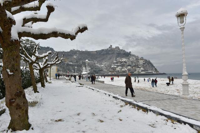 People walk along the beach covered with snow after a heavy snowfall in San Sebastian, northern Spain, on February 28, 2018. School was cancelled across swathes of Europe as a blast of Siberian weather dubbed the "Beast from the East" kept the mercury far below zero. (AFP) People walk along the beach covered with snow after a heavy snowfall in San Sebastian, northern Spain, on February 28, 2018. School was cancelled across swathes of Europe as a blast of Siberian weather dubbed the "Beast from the East" kept the mercury far below zero. (AFP)