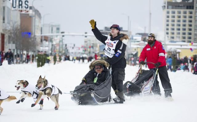 Iditarod musher Allen Moore waves to the crowd. Moore has just won the Yukon Quest, a dog sled race from Whitehorse, Yukon Territory to Fairbanks, Alaska. (AP) Iditarod musher Allen Moore waves to the crowd. Moore has just won the Yukon Quest, a dog sled race from Whitehorse, Yukon Territory to Fairbanks, Alaska. (AP)
