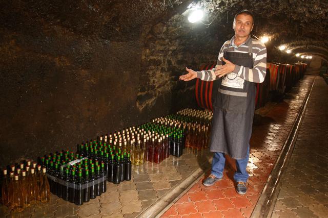 Vasyl Nad, a 54-year-old winemaker, gestures as he talks with a visitor in his wine cellar in Beregove. (AFP) Vasyl Nad, a 54-year-old winemaker, gestures as he talks with a visitor in his wine cellar in Beregove. (AFP)