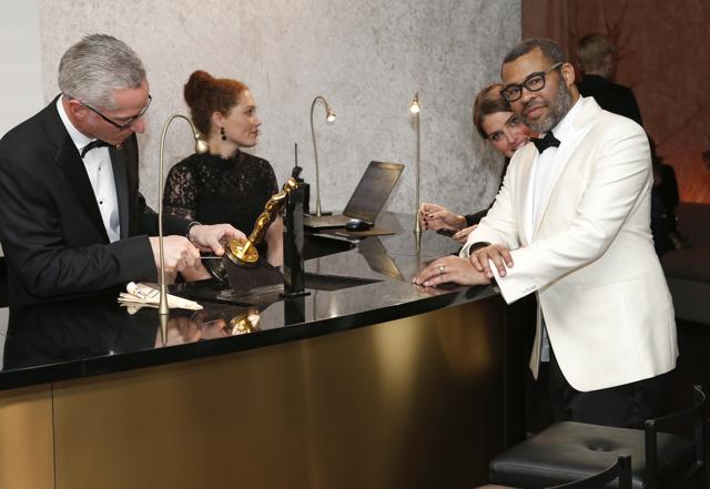 Jordan Peele picks up his Oscar as he attends the Governors Ball after the Oscars on Sunday. (Eric Jamison/Invision/AP) Jordan Peele picks up his Oscar as he attends the Governors Ball after the Oscars on Sunday. (Eric Jamison/Invision/AP)