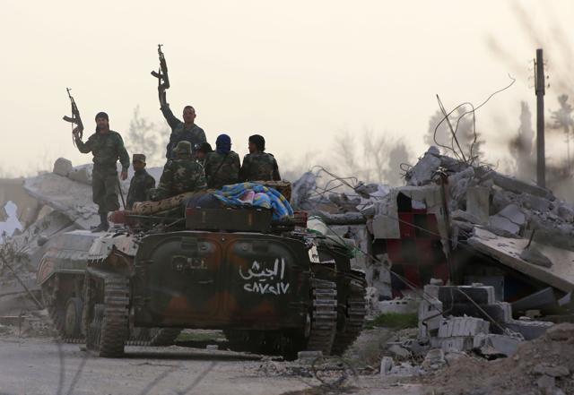 Syrian government forces brandish their weapons while standing on an armoured personnel carrier after entering al-Shifoniya as they advance in the rebel-held Eastern Ghouta area on March 4. (AFP Photo) Syrian government forces brandish their weapons while standing on an armoured personnel carrier after entering al-Shifoniya as they advance in the rebel-held Eastern Ghouta area on March 4. (AFP Photo)