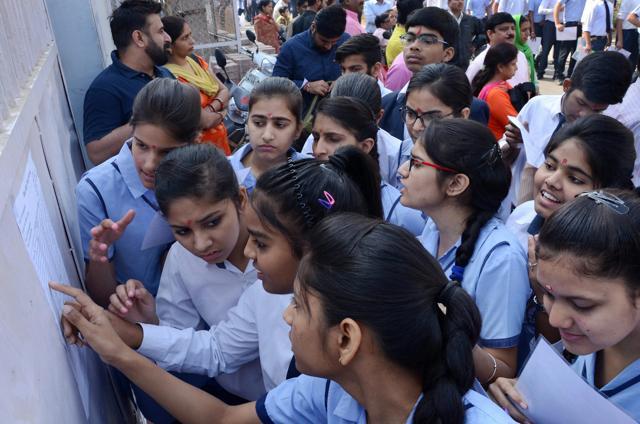 Class 10 students appearing for CBSE board exams check their seat allocation outside an examination center in Gurugram on Tuesday. (PTI) Class 10 students appearing for CBSE board exams check their seat allocation outside an examination center in Gurugram on Tuesday. (PTI)