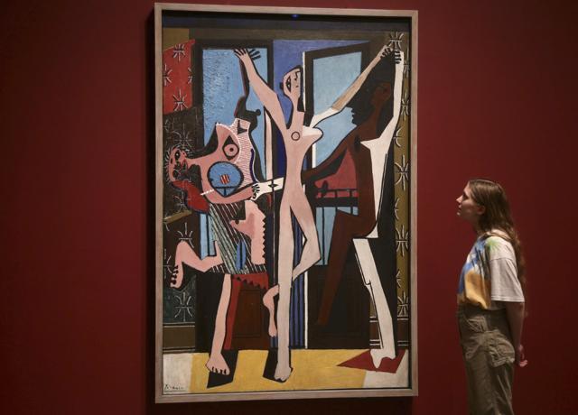 A woman looking at Pablo Picasso's The Three Dancers, 1925, during a preview of the exhibition Picasso 1932 - Love, Fame, Tragedy at Tate Modern in London. (AP) A woman looking at Pablo Picasso's The Three Dancers, 1925, during a preview of the exhibition Picasso 1932 - Love, Fame, Tragedy at Tate Modern in London. (AP)