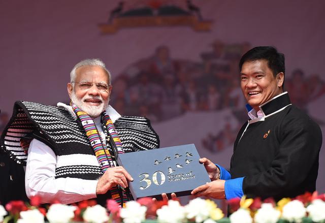 Prime Minister Narendra Modi and Chief Minister of Arunachal Pradesh, Pema Khandu, presenting a gift to mark the 30 years of statehood at the inauguration of the Dorjee Khandu State Convention Centre in Itanagar. (PIB) Prime Minister Narendra Modi and Chief Minister of Arunachal Pradesh, Pema Khandu, presenting a gift to mark the 30 years of statehood at the inauguration of the Dorjee Khandu State Convention Centre in Itanagar. (PIB)