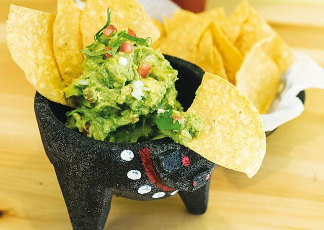 Guacamole, the ancient Aztec dish based on mashed avocados, tomatoes, onions, coriander and chillis has travelled the world as a dip and bar snack (Getty Images)